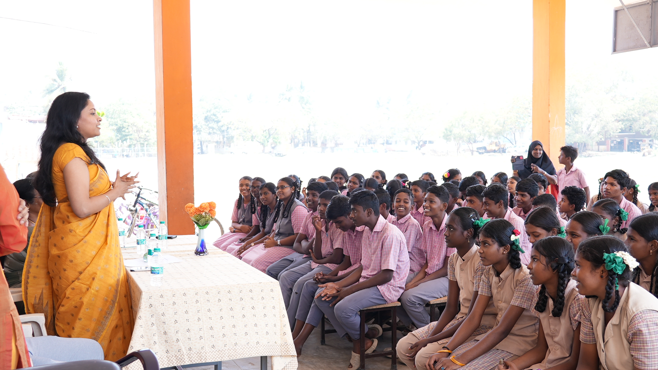 A volunteer speaks with students during an interactive session