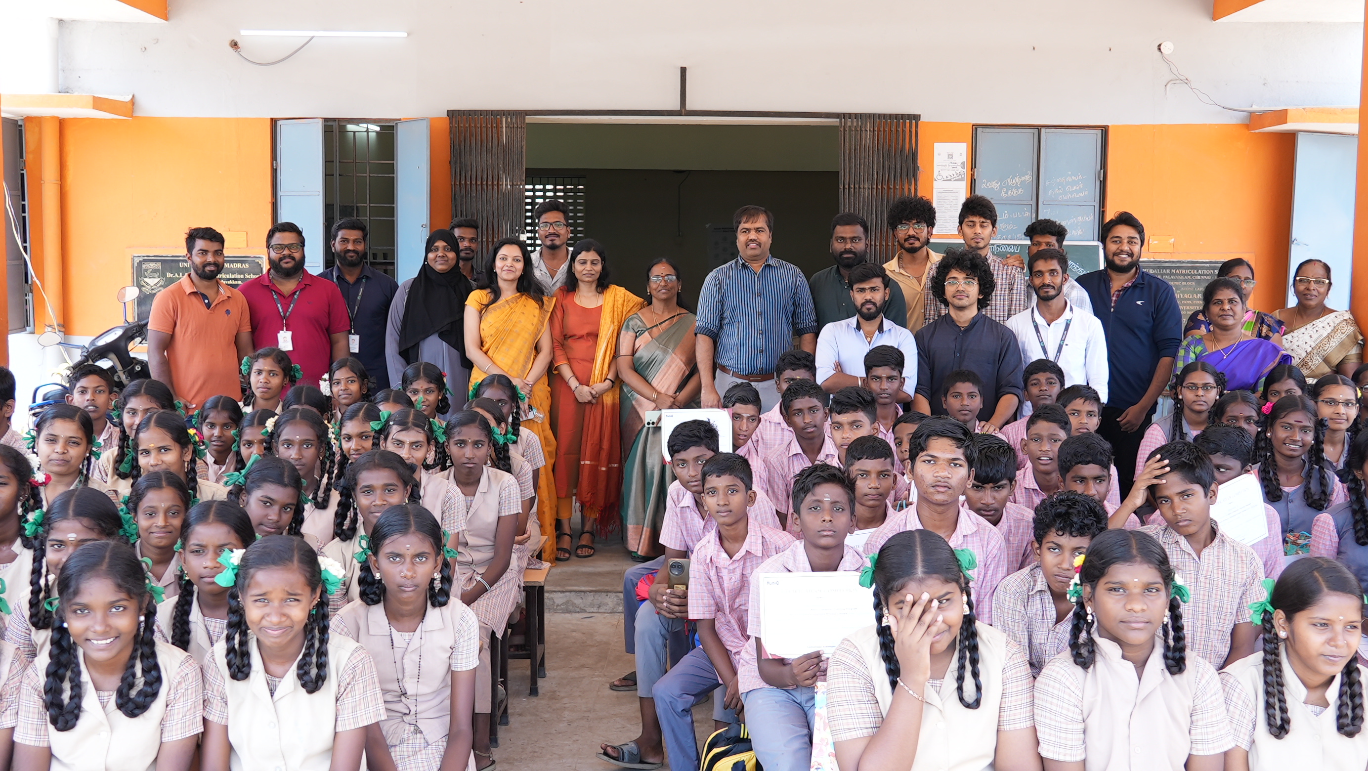 The full cohort of students, teachers, and volunteers together after the program