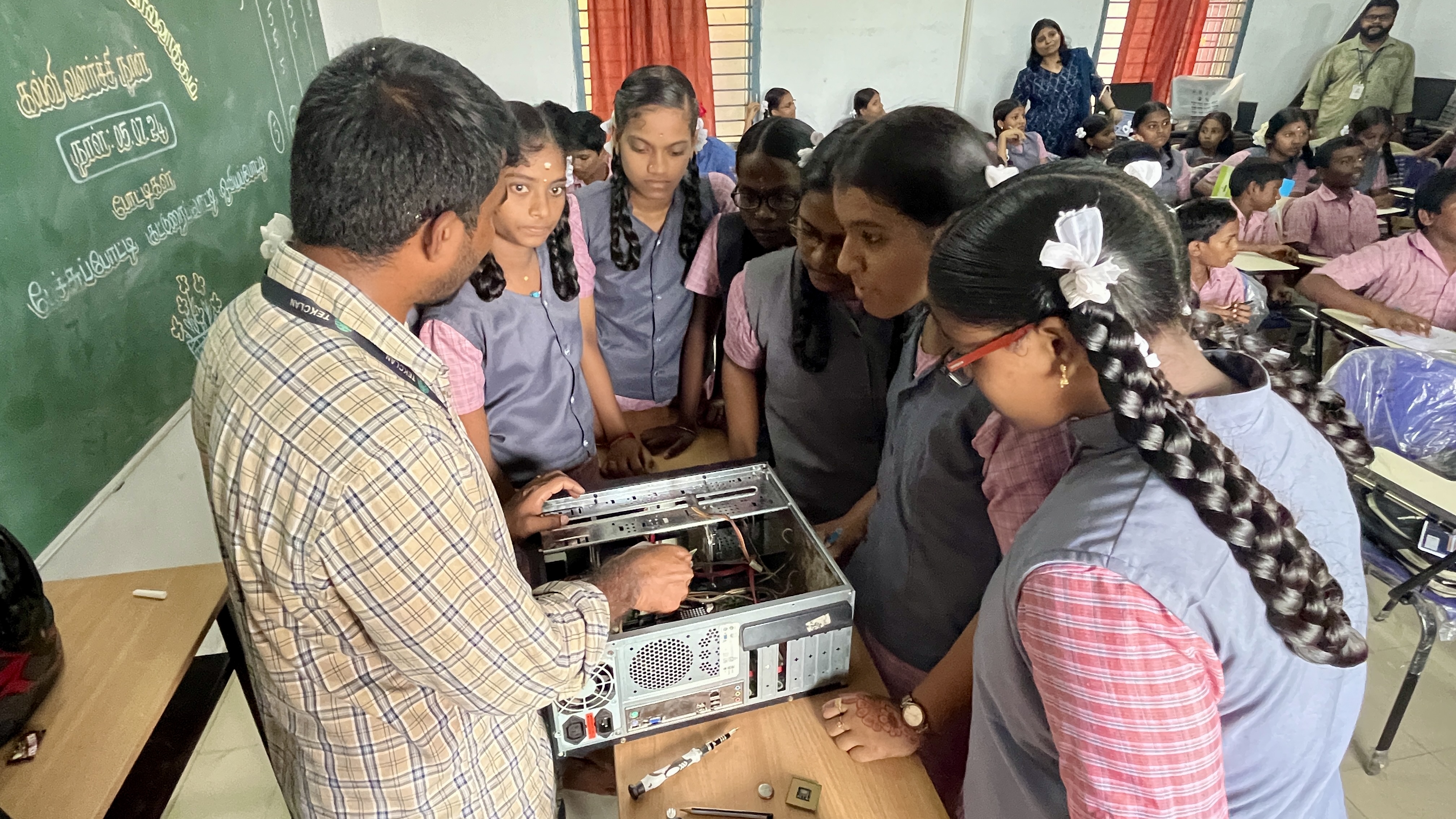 Students get a hands-on look inside a desktop computer during a hardware demonstration
