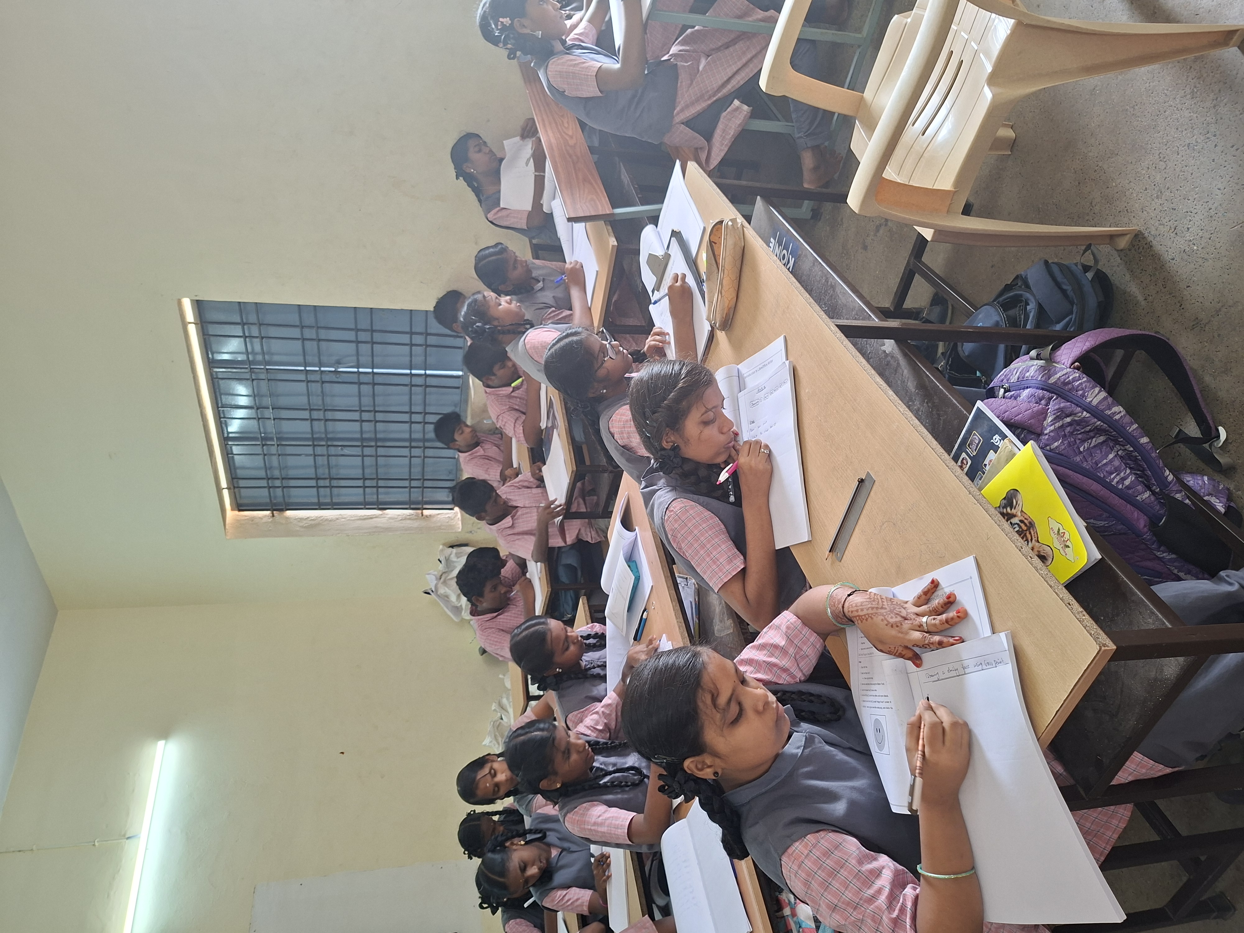 Students work through a hands-on coding worksheet at their desks