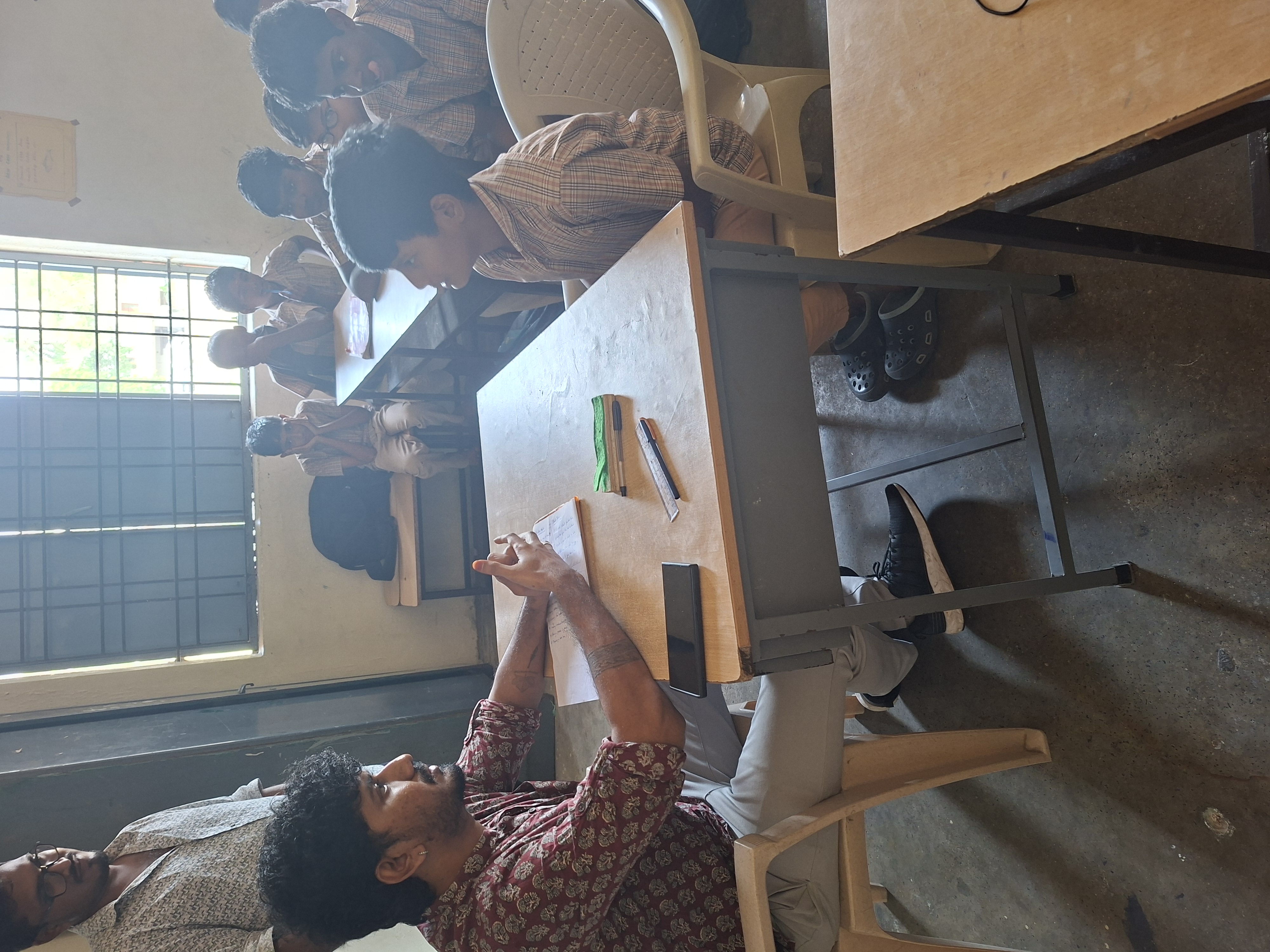 Volunteers jot down notes during a classroom visit
