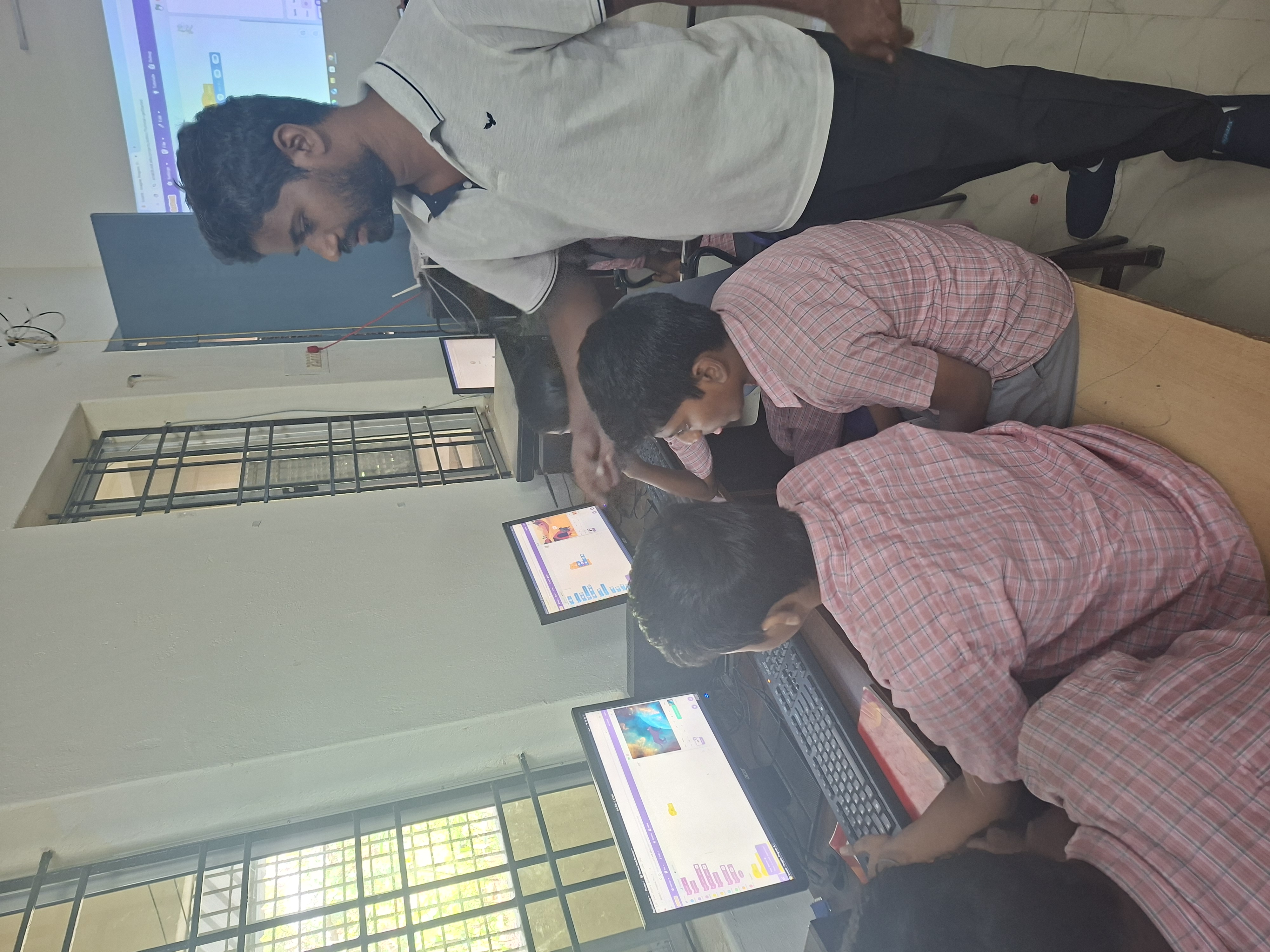 Students try out an interactive coding exercise on laptops